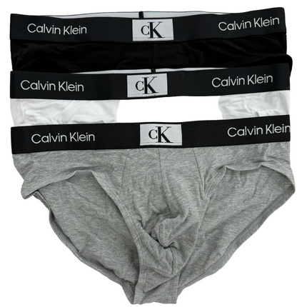 Two pairs of Calvin Klein underwear, one black and one gray, on a white background.